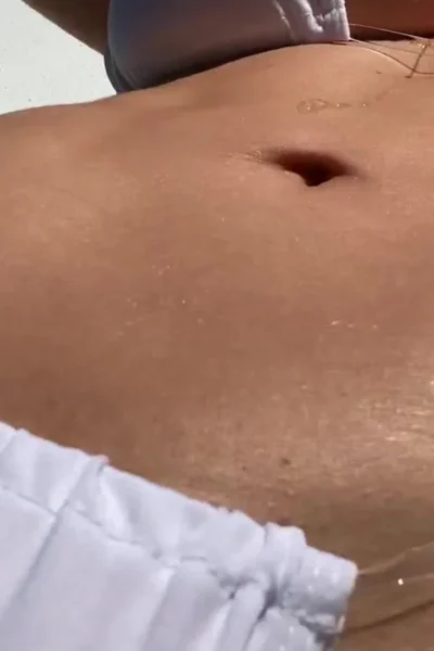 Genesis Mia Lopez oiling up her sexy bikini body by the pool