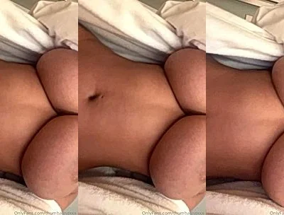 THUMBALINA showing off her naked big boobies in the bedsheets